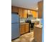 Full kitchen showing stainless steel appliances, wood cabinets and countertops at 2225 Buchtel Blvd # 207, Denver, CO 80210