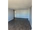 A well-lit living room with wood-look floors, and light gray walls at 2225 Buchtel Blvd # 207, Denver, CO 80210