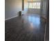 Living room with new hardwood floors, large window, and view of the outdoors at 2225 Buchtel Blvd # 207, Denver, CO 80210