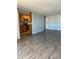 A well-lit living room with wood-look floors and an attached kitchen at 2225 Buchtel Blvd # 207, Denver, CO 80210