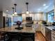 Bright kitchen boasts stainless steel appliances, granite countertops, and a large center island with bar seating at 8908 Jellison Ct, Westminster, CO 80021