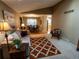 Cozy living room with comfortable seating, a decorative rug, and a view into the dining area at 8908 Jellison Ct, Westminster, CO 80021
