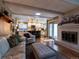 Open concept living space features hardwood floors, a fireplace, and seamless access to a modern kitchen at 8908 Jellison Ct, Westminster, CO 80021