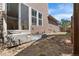 Backyard featuring grass and wood fence and the back of the house at 10859 E 25Th Dr, Aurora, CO 80010