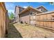 Backyard featuring a wood fence and the back of the house at 10859 E 25Th Dr, Aurora, CO 80010