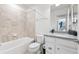 Bathroom featuring a bathtub, toilet and sink with white cabinets at 10859 E 25Th Dr, Aurora, CO 80010
