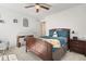 This bedroom features a ceiling fan, carpeted floors and a mirror on the wall at 10859 E 25Th Dr, Aurora, CO 80010