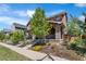 Charming two-story home featuring stone accents, a welcoming porch, and beautifully landscaped front yard at 10859 E 25Th Dr, Aurora, CO 80010