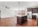 Modern kitchen with stainless steel appliances, island with breakfast bar, and open to the living area at 10859 E 25Th Dr, Aurora, CO 80010