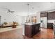 Spacious kitchen featuring a large island, stainless steel appliances, and dark wood cabinetry in a modern setting at 10859 E 25Th Dr, Aurora, CO 80010