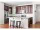 Well-lit kitchen featuring an island with seating, granite countertops, and stainless steel appliances at 10859 E 25Th Dr, Aurora, CO 80010