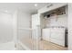 Convenient upstairs laundry room with washer, dryer, and shelving for storage at 10859 E 25Th Dr, Aurora, CO 80010