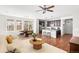 Bright open concept living room with a large kitchen island, hardwood floors, and a cozy seating area at 10859 E 25Th Dr, Aurora, CO 80010