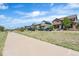 A street view of homes with various colors and designs with manicured lawns at 10859 E 25Th Dr, Aurora, CO 80010