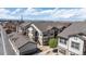 Wide aerial shot of condo exteriors surrounded by parking spaces and greenery at 4630 Copeland Cir # 201, Highlands Ranch, CO 80126