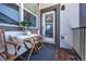 Cozy balcony features stylish wood tile floor, table with chairs, and great natural light at 4630 Copeland Cir # 201, Highlands Ranch, CO 80126