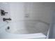 Close up of tiled tub with polished chrome fixtures and white porcelain at 4630 Copeland Cir # 201, Highlands Ranch, CO 80126