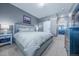 Comfortable bedroom features a sliding barn door for bathroom access and neutral decor at 4630 Copeland Cir # 201, Highlands Ranch, CO 80126