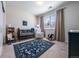 Charming Bedroom with rocking horse, rug, crib and ample natural light from a large window at 4630 Copeland Cir # 201, Highlands Ranch, CO 80126