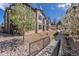 Attractive apartment building with beige siding, black railings, stone landscaping, and a blossoming tree at 4630 Copeland Cir # 201, Highlands Ranch, CO 80126