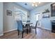 Cozy dining area featuring a round table, comfortable chairs, modern lighting, and access to the outdoors at 4630 Copeland Cir # 201, Highlands Ranch, CO 80126