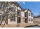 Charming two-story apartment building with neutral siding, black balcony railings, and blossoming tree at 4630 Copeland Cir # 201, Highlands Ranch, CO 80126