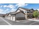 View of condo exterior with garages, a fire hydrant and a blue sky at 4630 Copeland Cir # 201, Highlands Ranch, CO 80126