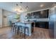 Bright and airy kitchen boasts stylish island with seating, sleek appliances, and ample cabinetry at 4630 Copeland Cir # 201, Highlands Ranch, CO 80126