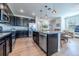 Open kitchen boasts sleek black cabinetry, stainless appliances and eat-in kitchen island with seating at 4630 Copeland Cir # 201, Highlands Ranch, CO 80126