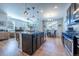 Bright and airy kitchen boasts stylish island with seating, sleek appliances, and open floor plan at 4630 Copeland Cir # 201, Highlands Ranch, CO 80126