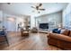 Well-lit living room with modern flooring, comfortable seating, and a view into the dining and kitchen areas at 4630 Copeland Cir # 201, Highlands Ranch, CO 80126