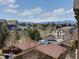 Scenic neighborhood view with well-maintained homes and mountain backdrop under a bright, cloudy sky at 4630 Copeland Cir # 201, Highlands Ranch, CO 80126