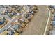 Aerial view of a property, highlighting its position near an open space, solar panel array and shed at 13463 Quivas St, Westminster, CO 80234