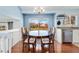 Charming dining area featuring hardwood floors, an attractive chandelier and large picture window at 13463 Quivas St, Westminster, CO 80234