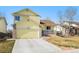 Charming yellow two-story home with an attached garage and landscaped front yard at 13463 Quivas St, Westminster, CO 80234