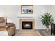 Living room fireplace with stone surround and mantel at 13463 Quivas St, Westminster, CO 80234