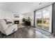 Comfortable living room featuring a fireplace, slider door, and hardwood floors at 13463 Quivas St, Westminster, CO 80234