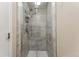 Updated shower with glass doors and tiled surround providing a spa-like experience at 13463 Quivas St, Westminster, CO 80234