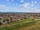 Stunning aerial view of the community and golf course, showcasing lush greenery and mountain views in the distance at 2182 S Victor St # D, Aurora, CO 80014