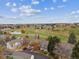 Scenic aerial view of the property overlooking a lush golf course and serene pond on a sunny day at 2182 S Victor St # D, Aurora, CO 80014
