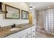 Bright bathroom with granite countertop, neutral tile floor, and shower with tub combo at 2182 S Victor St # D, Aurora, CO 80014