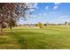 Scenic view of the well-maintained golf course surrounded by mature trees and blue sky at 2182 S Victor St # D, Aurora, CO 80014