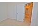 Bright bedroom featuring neutral carpet and a closet with white sliding doors at 9568 W San Juan Cir # 307, Littleton, CO 80128
