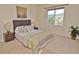 Bedroom with neutral paint, carpet, and view to the lush backyard at 9568 W San Juan Cir # 307, Littleton, CO 80128