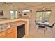 Open dining area with a breakfast bar and a walk-out to the porch at 9568 W San Juan Cir # 307, Littleton, CO 80128