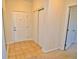 Bright entryway featuring tile flooring, closet, and a solid white front door at 9568 W San Juan Cir # 307, Littleton, CO 80128