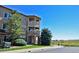 Beautiful condo exterior with stone accents, arched entryway, and charming balconies on a sunny day at 9568 W San Juan Cir # 307, Littleton, CO 80128