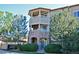 Elegant condo exterior featuring stacked stone accents, multiple balconies, and manicured landscaping at 9568 W San Juan Cir # 307, Littleton, CO 80128
