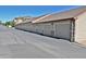 Row of garages for townhome residents, each with a garage door and lighting at 9568 W San Juan Cir # 307, Littleton, CO 80128