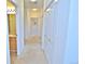 Hallway with neutral carpet, white trim, and access to rooms including the bathroom at 9568 W San Juan Cir # 307, Littleton, CO 80128